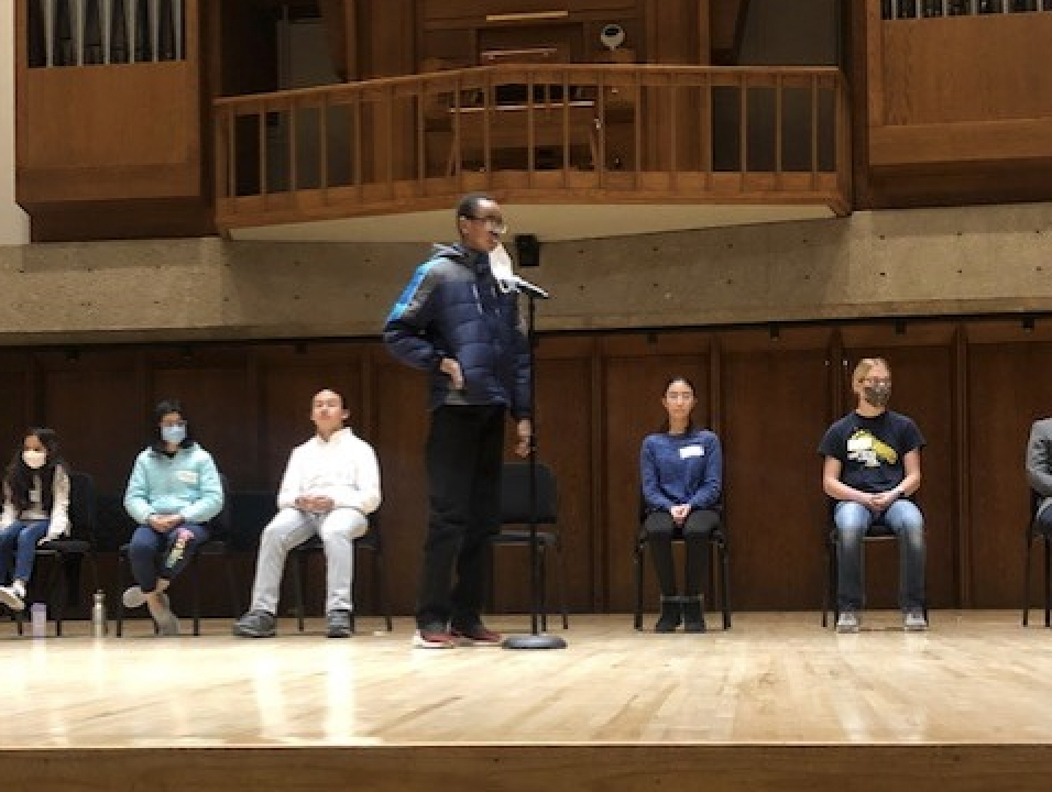  speller stands at the mic on stage